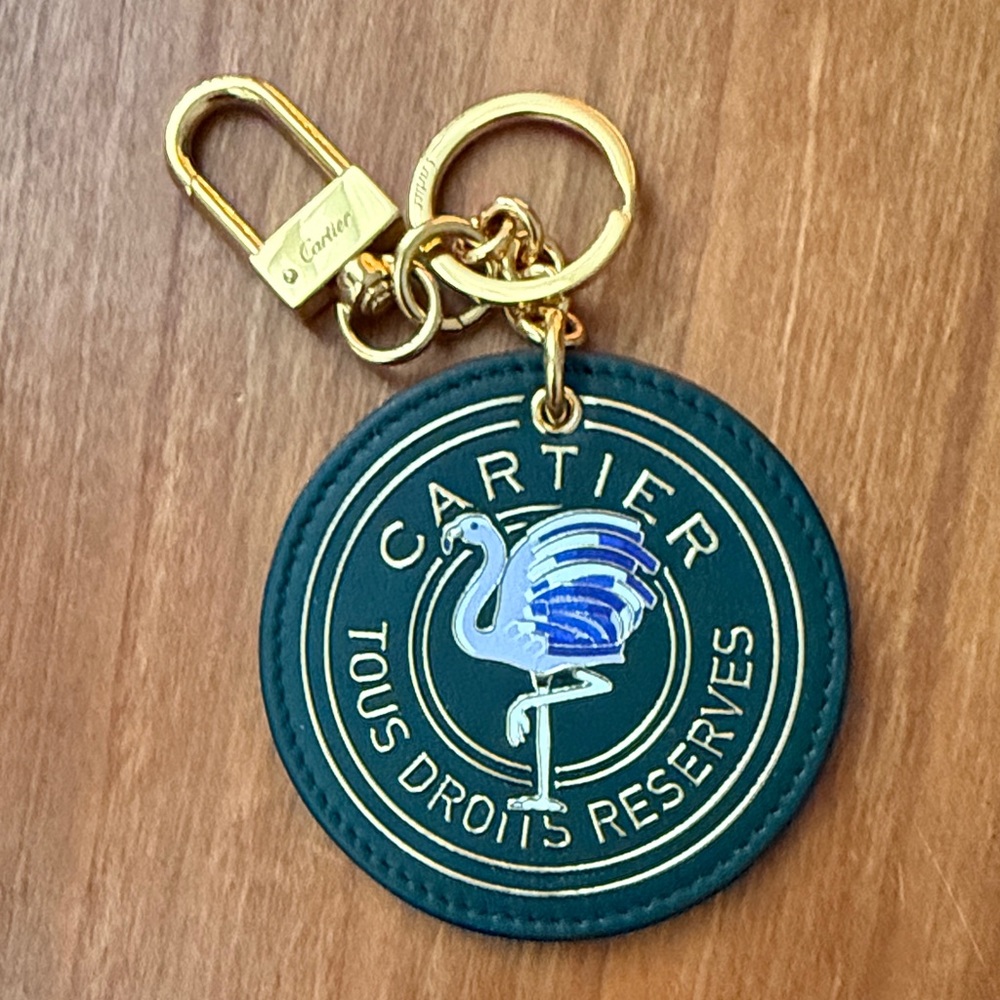 Rare Cartier Blue and Gold Flamingo Keychain on Green Leather.